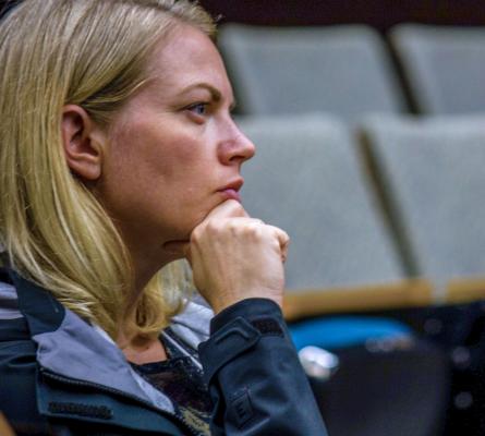 Woman listens intently at event