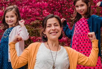 a mom with her two daughters doing a strength pose