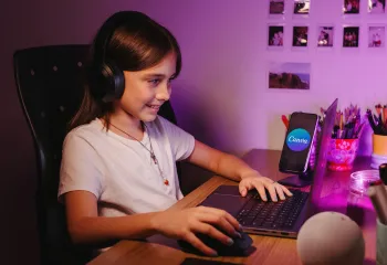 Girl wearing headphones at a computer