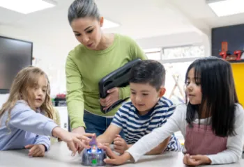 Three children and an adult in a science classroom