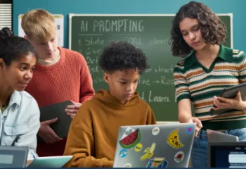 Group of teen students around a laptop