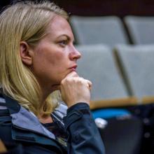 Woman listens intently at event