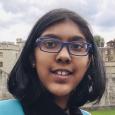 Photo of girl with short, dark hair and blue glasses