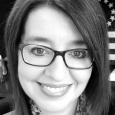 Black and white photo of woman with dark hair and glasses