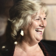 Profile of smiling woman with short blonde hair