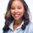 Women with dark hair wearing blue blazer and white shirt