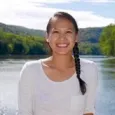 Jessica Hua - woman with dark hair in a braid standing in front of a lake