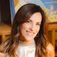 Sheryl Haft - woman with long brown hair wearing a white sleeves blouse