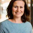 Erica Meehan - Photo of woman with brown hair wearing a blue checked shirt