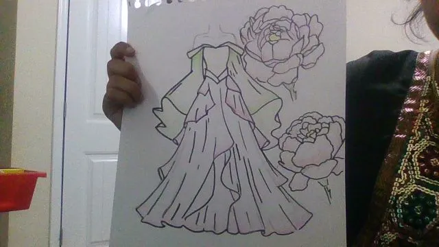 girl off screen holding a drawing of a formal gown and flowers